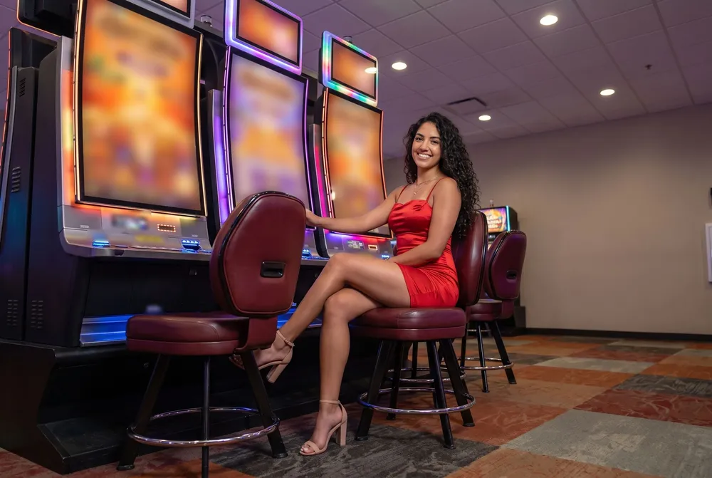 Woman in red by a bank of slot machines