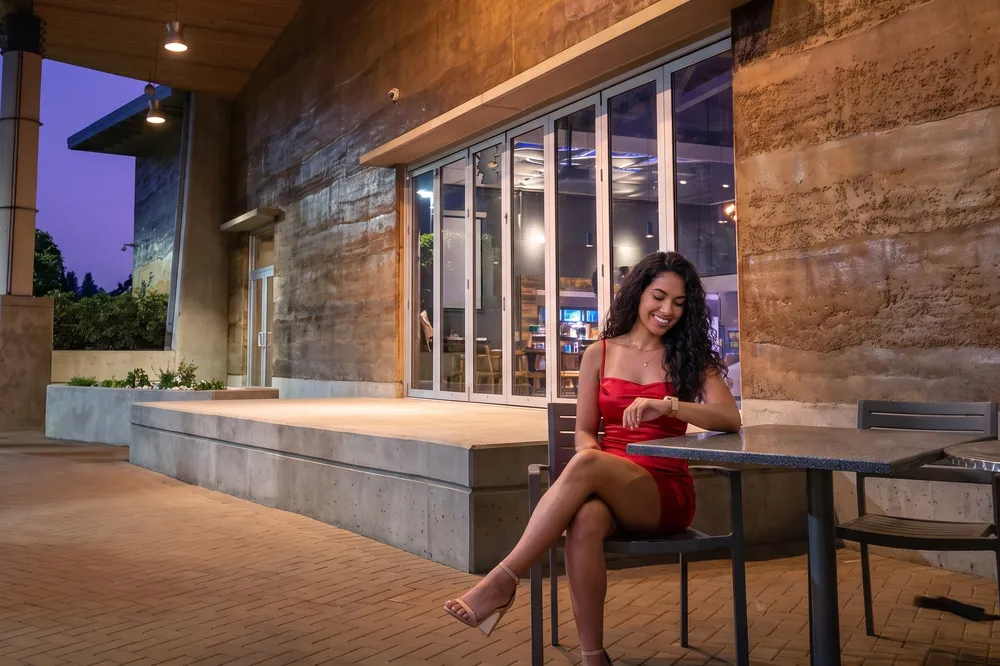 Woman in red on the casino patio at dusk