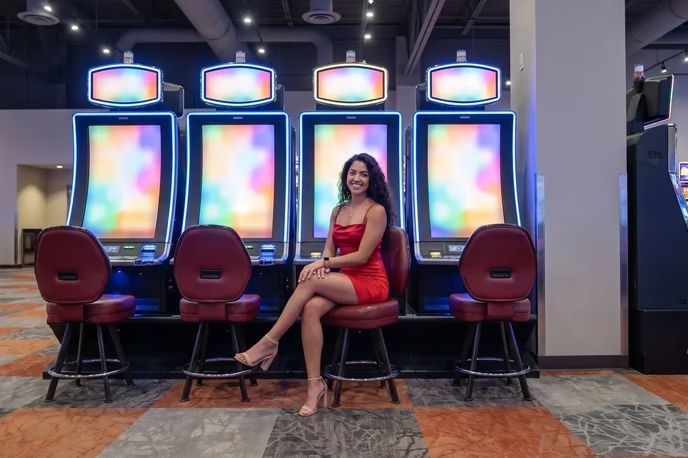 Woman in red on a stool on the casino floor
